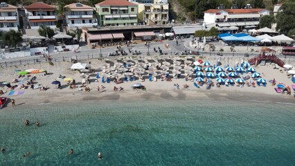 Aerial drone view parga greece, beach crowded with tourists in vacation on summer in famous greek caribbean parga town epirus preveza