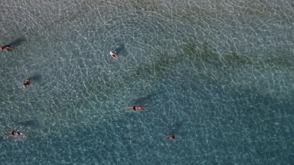 Aerial drone view parga greece, beach crowded with tourists in vacation on summer in famous greek caribbean parga town epirus preveza