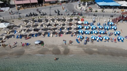 Aerial drone view parga greece, beach crowded with tourists in vacation on summer in famous greek caribbean parga town epirus preveza