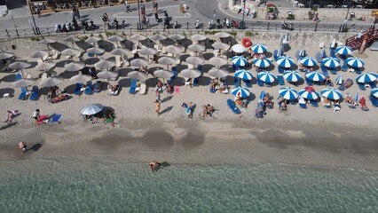 Aerial drone view parga greece, beach crowded with tourists in vacation on summer in famous greek caribbean parga town epirus preveza