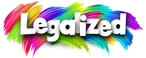 Legalized paper word sign with colorful spectrum paint brush strokes over white.