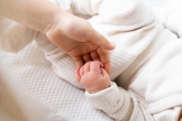 children's hands, the meeting of a newborn and an older child, the concept of the relationship between children in the family, brother and sister
