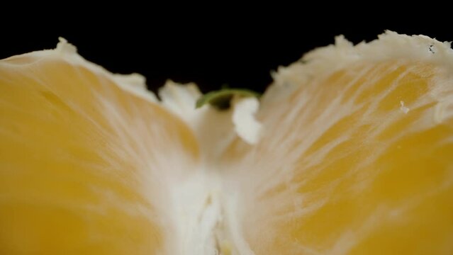 The camera glides between the Tangerine segments with green peel.
