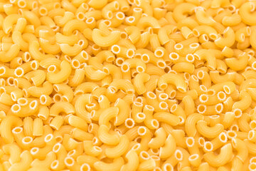 Uncooked Chifferi Rigati Pasta Background. Fat and Unhealthy Food. Classic Dry Macaroni Texture. Italian Culture and Cuisine. Raw Pasta