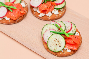 Crispy Cracker Sandwiches with Fresh Salmon, Cucumber, Radish, Cottage Cheese and Green Onions. Easy Breakfast. Quick and Healthy Sandwiches. Crispbread with Tasty Filling. Healthy Dietary Snack