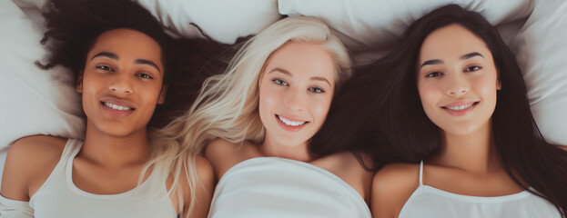 Top view headshot of lesbian trouple lying in bed- Three multi ethnic females sleeping in bed. Polygamic concept - obrazy, fototapety, plakaty