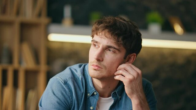 Unmotivated freelancer sitting home looking in distance close up. Tired worker