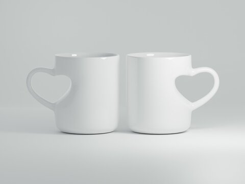 Realistic 11 oz Heart Shaped Handle Ceramic Mugs Mock Up on a White Background as 3D Rendering - Two Mugs.