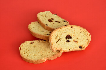 Fototapeta na wymiar Sweet dry crackers with raisins lie on a red background.
