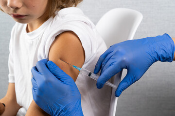 vaccination of children, a little boy at a doctor's appointment, an injection in the arm,...