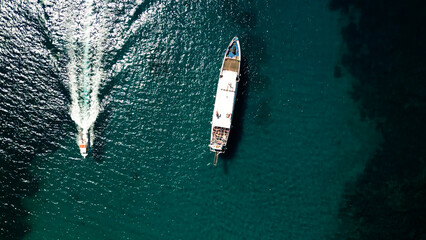 Vertical aerial view of two sailing ships in blue sea water © Nade