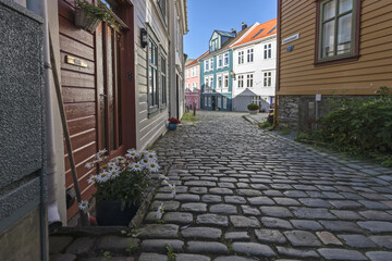 Bergen, Norway - July 28, 2022: Wooden buildings along the Knosesmauet street in old Bergen, Scandinavia