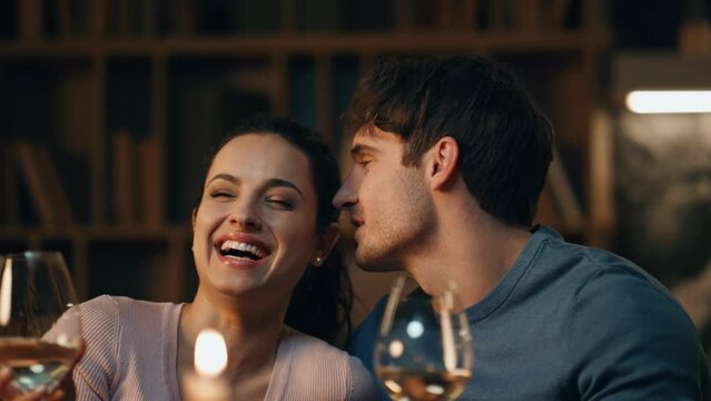 Gentle couple laughing romantic date with wine at home close up. Loving spouses