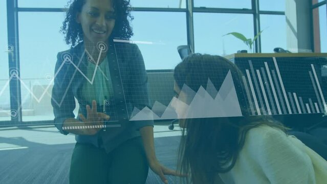 Animation of graphs, loading bars and map over diverse female coworkers discussing on desk