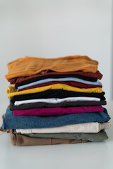 colored clothes folded and stacked on a white background