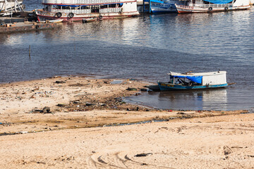 AMAZONAS, DRY - Houseboats are stranded on the edge of the region known as Manaus Moderna, the...