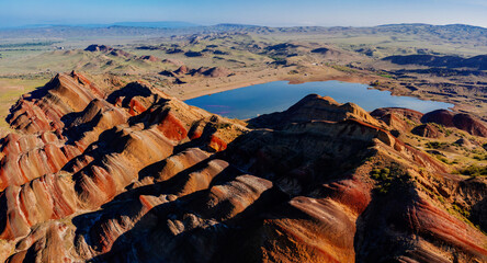 Dawn on beautiful landscape of layered striped red mountains in Georgia