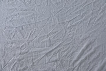 Crumpled white fabric as background, top view