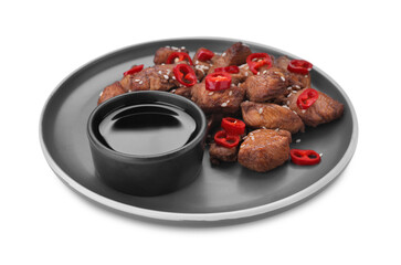 Plate with tasty soy sauce, roasted meat, sesame and chili pepper isolated on white