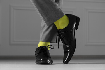 Man wearing stylish shoes and yellow socks indoors, closeup