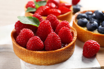 Tartlet with fresh raspberries on table, closeup. Delicious dessert