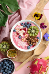 Obraz na płótnie Canvas Flat lay composition with tasty smoothie bowl on pink table