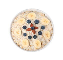Tasty boiled oatmeal with banana, blueberries and almonds in bowl isolated on white, top view