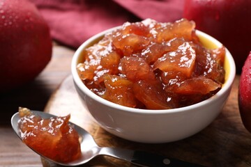 Delicious apple jam and fresh fruits on wooden table, closeup
