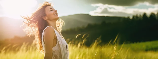 Fotobehang Backlit Portrait of calm happy smiling free woman with closed eyes enjoys a beautiful moment life on the fields at sunset © Adriana