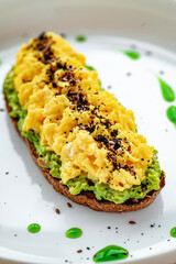 Scrambled on toast with guacamole and olives