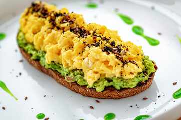 Scrambled on toast with guacamole and olives