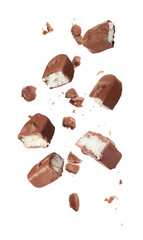 Pieces of delicious chocolate bars with coconut filling falling on white background