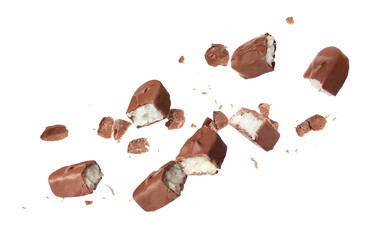 Pieces of delicious chocolate bars with coconut filling falling on white background