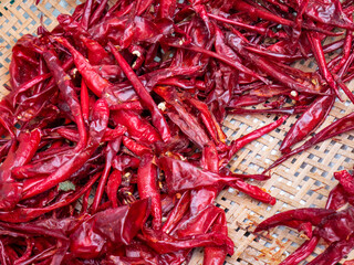 Fototapeta premium Dried red chilies on a winnowing pan 