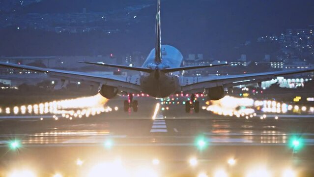 Large commercial airplane landing on runway, passenger landed safely at night. Journey abroad tourism, oversea travel, flight transit, air travel transport, airline business, transportation industry