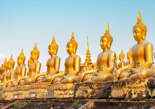 Many small,golden Buddha statues at Wat Phousalao,hilltop temple,reflecting sunset light,overlooking Mekong River,Pakse,southern Laos.