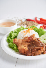 Fried chicken chop with pepper sauce served with rice and vegetables. Selective focus, isolated in white background