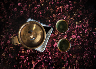 a pot of tea with a background of rosebuds. top view