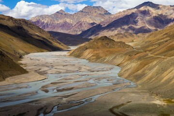 A breathtaking view of the Spiti Valley showcases the meandering Spiti River set against majestic...