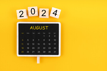 Calendar for August 2024 in black chalkboard with copy space.