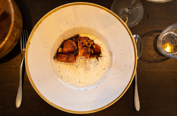 Dark roasted butter pumpkin with whipped creamy sauce make with Ossau-Iraty sheep cheese from Basque County France served in French restaurant in Bordeaux region