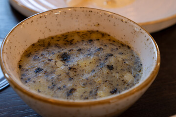 Side dish in restaurant in France, farm mashed potatoes cooked with green dried nori seaweed