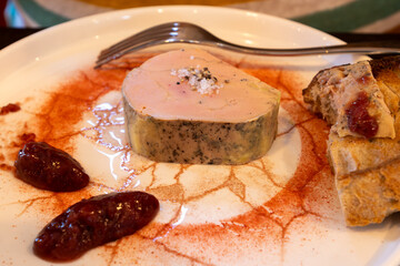 Foie gras fat liver specialty food product made of liver of a duck or goose fattened by gavage, force feeding, served in restaurant with strawberry jam