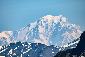 View on white snowy top of Mont Blanc highest mountain in Alps and Western Europe from mountain pass Col du Calibier in summer day, Hautes Alpes, France