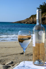 Summer time in Provence, two glasses of cold rose wine on Pampelonne sandy beach near Saint-Tropez in sunny day, Var, France