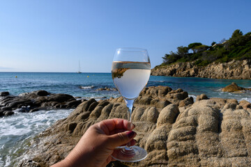 Summer time in Provence, two glasses of cold rose wine on Pampelonne sandy beach near Saint-Tropez in sunny day, Var, France - obrazy, fototapety, plakaty