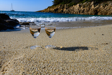 Summer time in Provence, two glasses of cold rose wine on Pampelonne sandy beach near Saint-Tropez in sunny day, Var, France