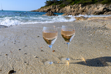 Summer time in Provence, two glasses of cold rose wine on Pampelonne sandy beach near Saint-Tropez in sunny day, Var, France