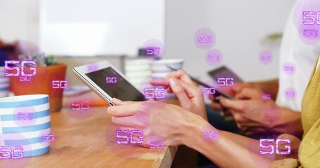 Animation of multiple 5g texts over diverse coworkers using digital tablets in office - Powered by Adobe