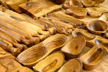Craft works on table, olive tree wooden kitchen utensils on farmers market in Provence, France